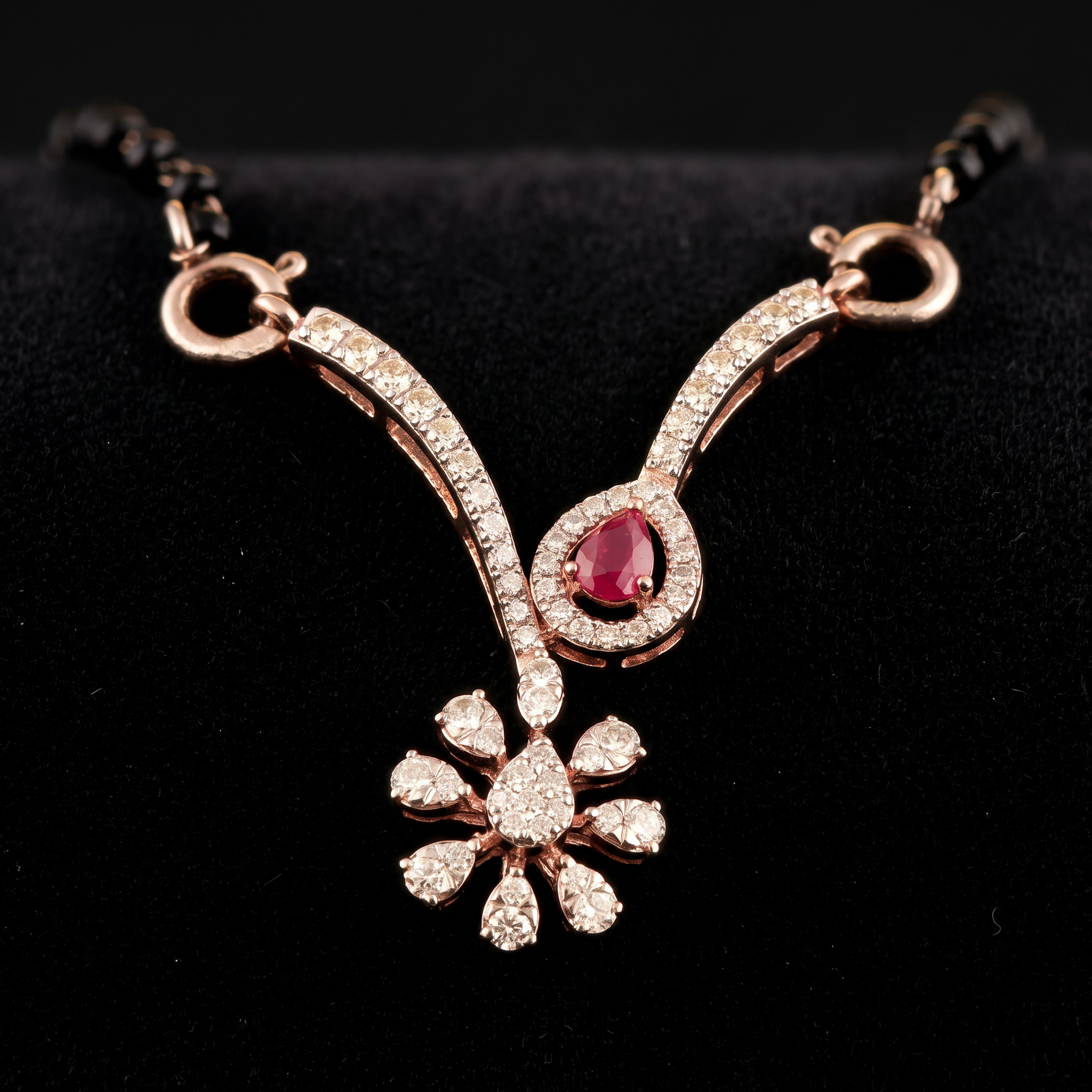 The Raktima Bindu — pear ruby V-drop mangalsutra with diamond blossom, 18kt rose gold